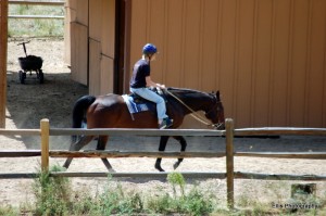 Sarah taking Ben around the stable at a walk.